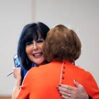 President Mantella hugging an alumna.